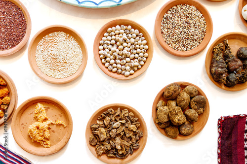 Close-up of mockup of ceramic vessels with dried Peruvian ingredients