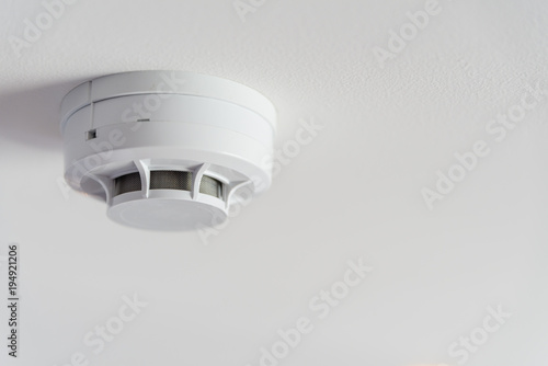 Fotografie Close up smoke detector on a ceiling.