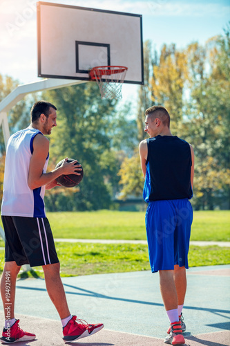 Two street basketball players on the basketball court photo