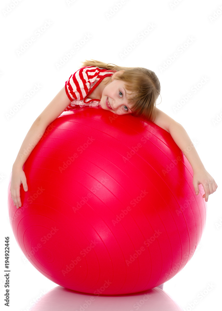 little girl doing exercises on a big ball for fitness. little girl doing exercises on a big ball for fitness.