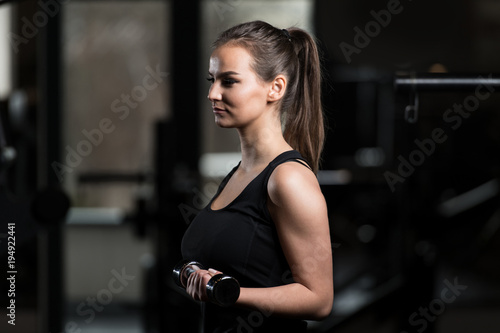 Healthy Young Woman Doing Exercise For Biceps