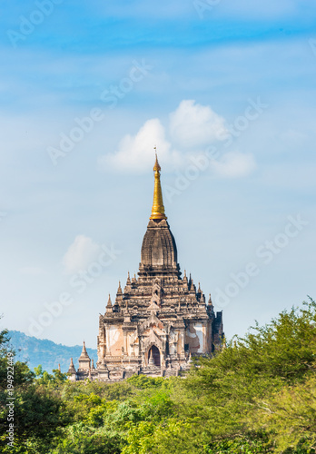 View of the facade of the building of the Shwegugyi temple in Bagan, Myanmar. Copy space for text. Vertical.
