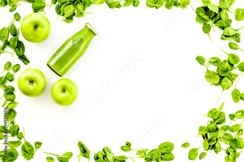 Green vegetables background with vegetable smoothies. Fresh apples, arugula salad on white background top view copy space