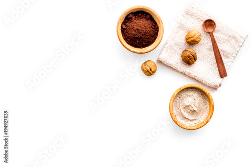 Natural cosmetics for skin care. Body scrub with walnut. White background top view copy space