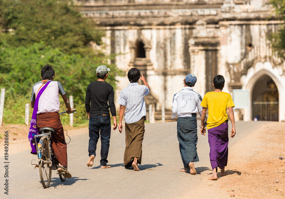 Group of a man walking on the road in Bagan, Myanmar. Copy space for text. Group of a man walking on the road in Bagan, Myanmar. Copy space for text.