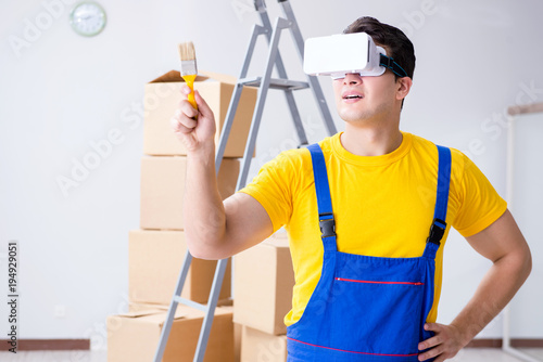 Painter contractor working with virtual reality goggles