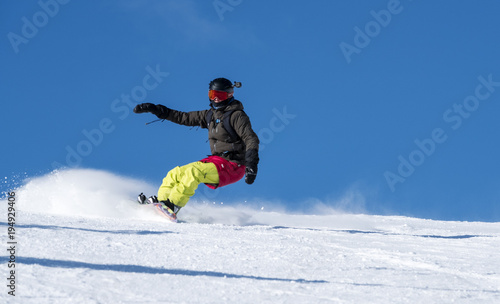 Woman Snowboarding Carving a Snowboard