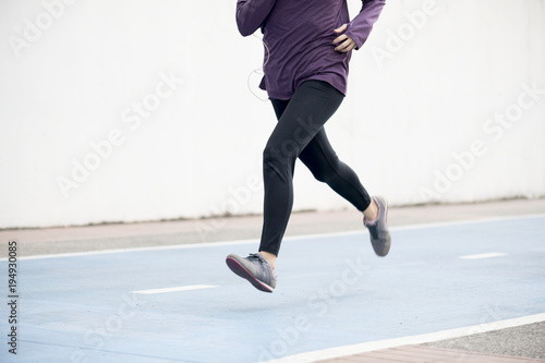 White woman running on track