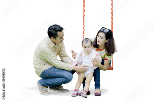Asian family playing with swing