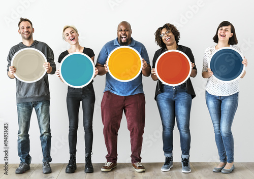 Diverse people holding blank round board photo