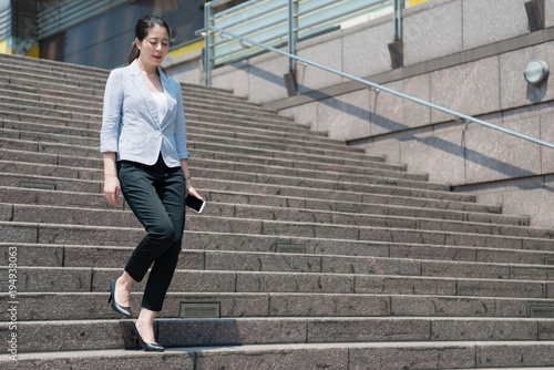 business woman walking down on the stair