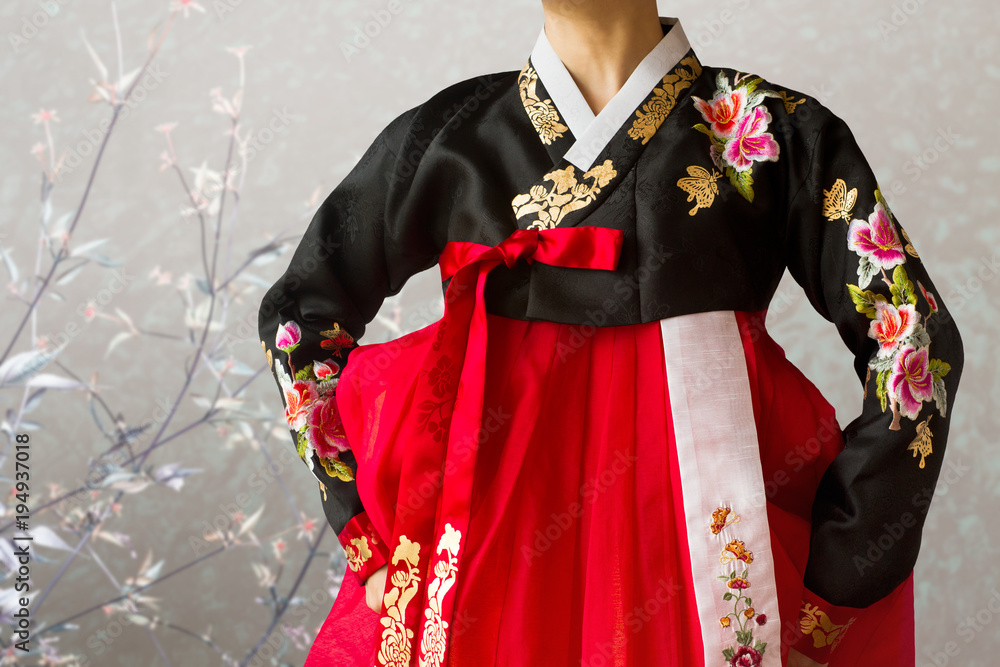 The woman wearing colorful Hanbok Korean traditional dress in the oriental flower background. Stock Adobe Stock