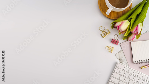 Styled stock photography white office desk table with blank notebook  computer  supplies and coffee cup. Top view with copy space. Flat lay.