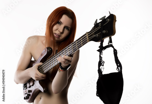 sexy nude rock woman playing on electric guitar on a white background.
