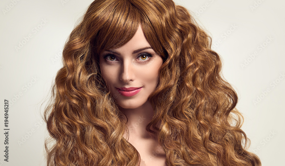 Fototapeta premium Portrait Gorgeous girl with Long and Shiny Curly Hair Smiling. Fashion Beautiful Young woman. Pretty European Model with fashion Trendy Stylish curly hairstyle. Hair beauty and Care concept