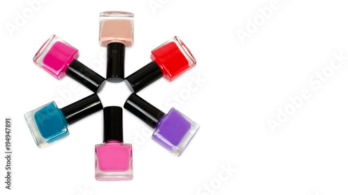 nail Polish laid out in shape of a flower or sun. Isolated on white background, copy space, template.