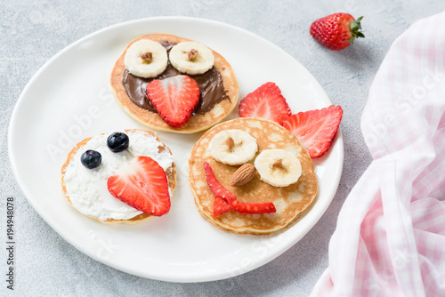 Pancakes art for kids on white plate. Colorful kids meal. Healthy breakfast concept