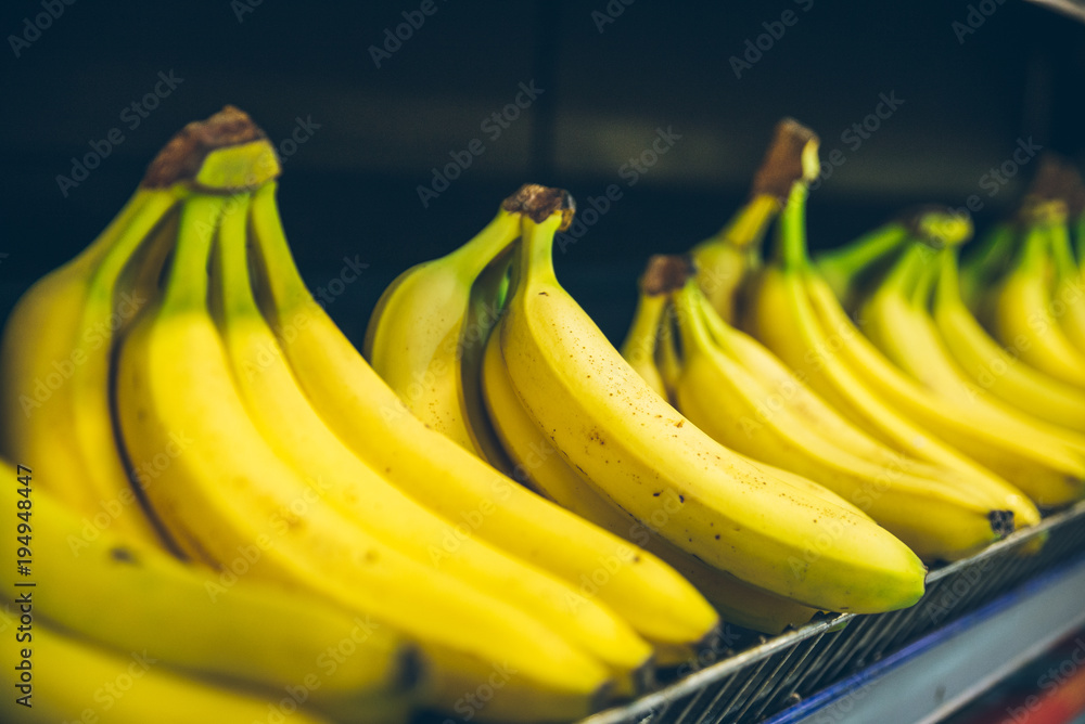 bananas branch on shelf of store