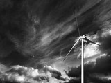 Wind turbine and black and white sky with storm clouds