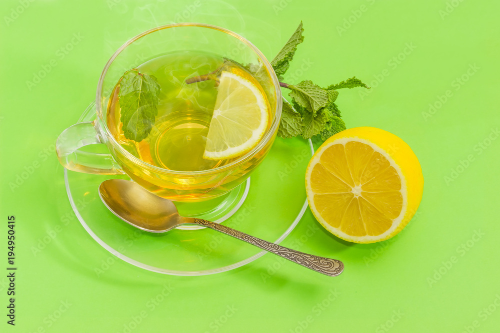 Tea with mint and lemon in glass cup Tea with mint and lemon in glass cup