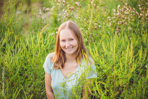 Young woman happy because no longer feels allergic to ragweed photo