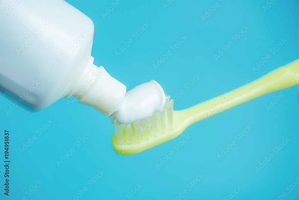 A toothbrush and toothpaste. 歯ブラシと歯磨き粉 水色背景 A toothbrush and toothpaste. 歯ブラシと歯磨き粉 水色背景