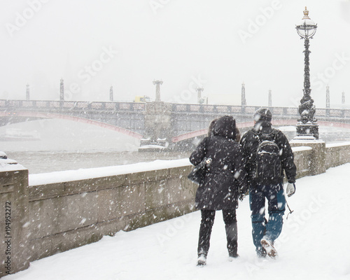 Couple Walking in Heavy Snow along the Albert Embankment in London
