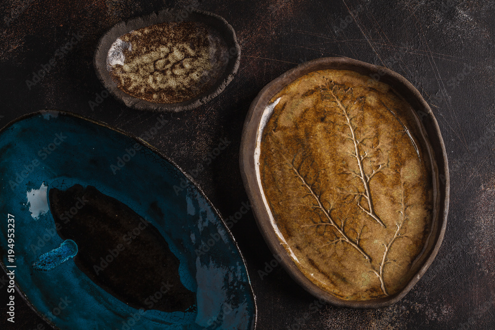 Beautiful vintage empty dark dishes on a dark rusty background. Copy space, top view.