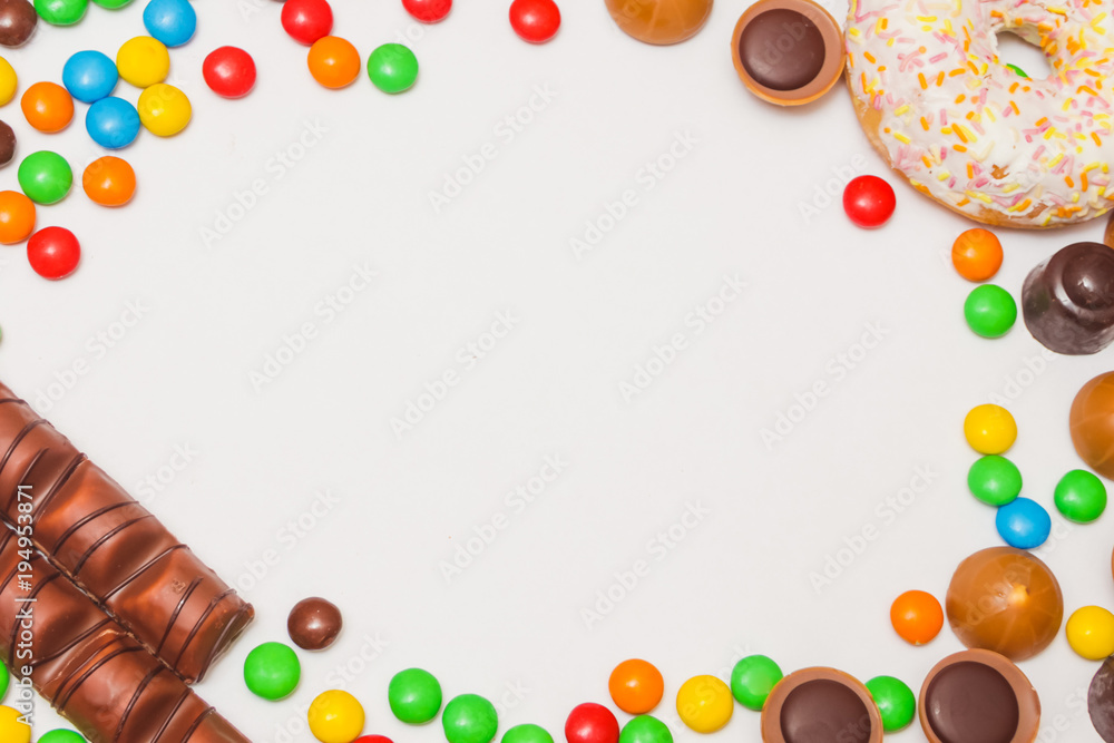 Background of sweets, with a white sheet for inscription. Sweets, sweets, chocolate on a pink background. sweet background. Background of sweets, with a white sheet for inscription. Sweets, sweets, chocolate on a pink background. sweet background.