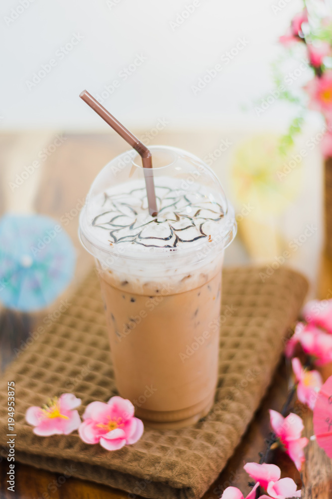 Ice coffee with whipped cream and topping on table Ice coffee with whipped cream and topping on table