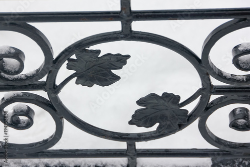 Artistic forging. Part of the forged fence. Leaves from metal.