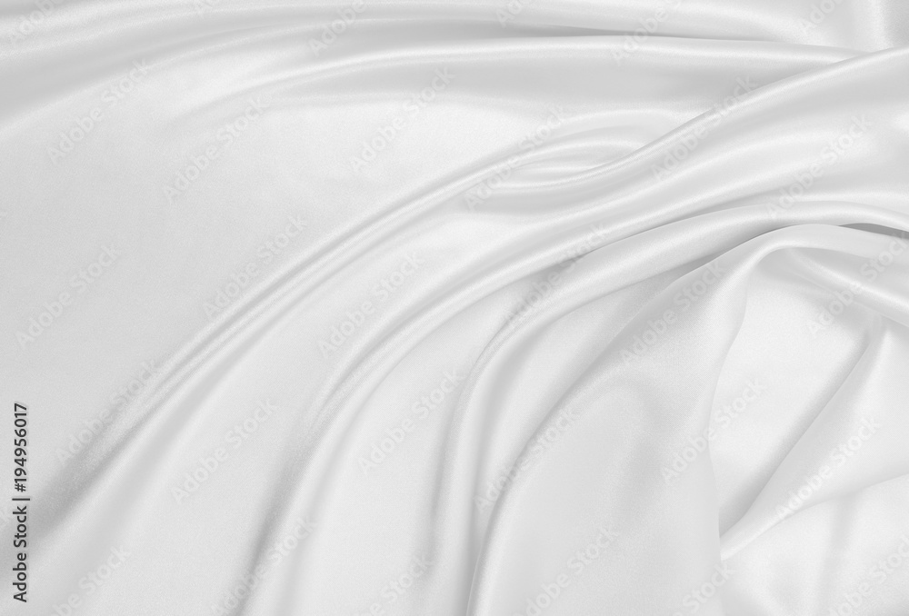 Smooth elegant white silk or satin luxury cloth texture as wedding background. Luxurious Christmas background or New Year background design Smooth elegant white silk or satin luxury cloth texture as wedding background. Luxurious Christmas background or New Year background design