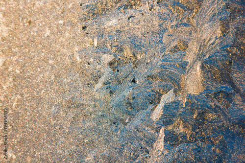 Frosty windows at sunset, close-up. Gold with silver. Stunning frosty background, frost artist.