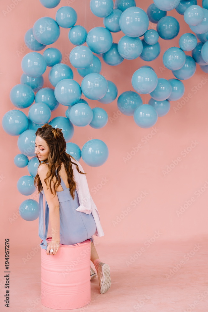 Fototapeta premium Sexy girl in a pink room sits in a pink barrel