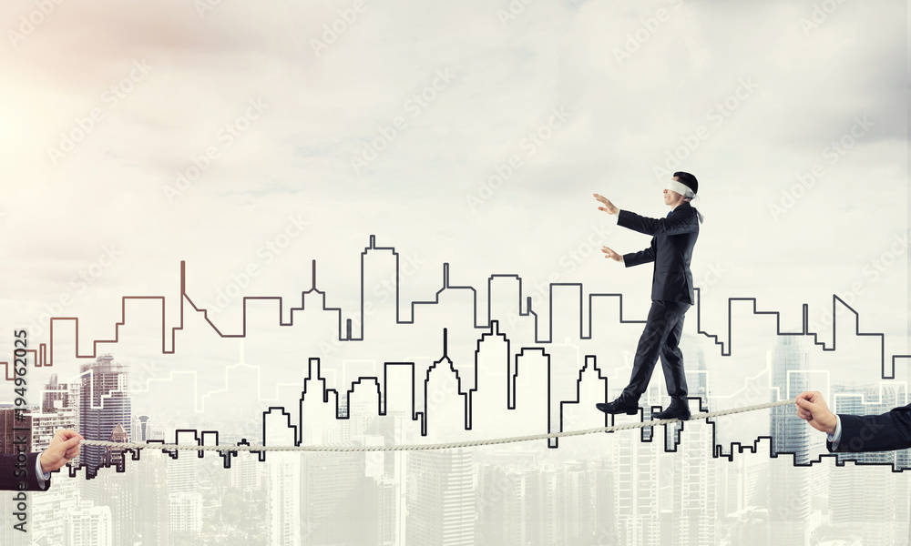 Business concept of risk support and assistance with man balancing on rope Business concept of risk support and assistance with man balancing on rope