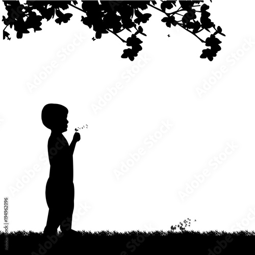 Boy blowing the dandelion in park under the tree silhouette, one in the series of similar images