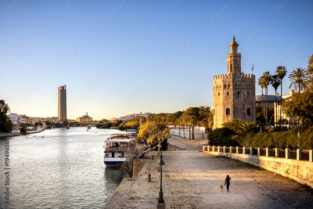 Fototapeta premium View of Golden Tower (Torre del Oro) of Seville, Andalusia, Spain over river Guadalquivir at sunset