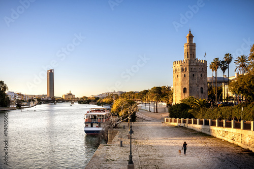 View of Golden Tower (Torre del Oro) of Seville, Andalusia, Spain over river Guadalquivir at sunset photo