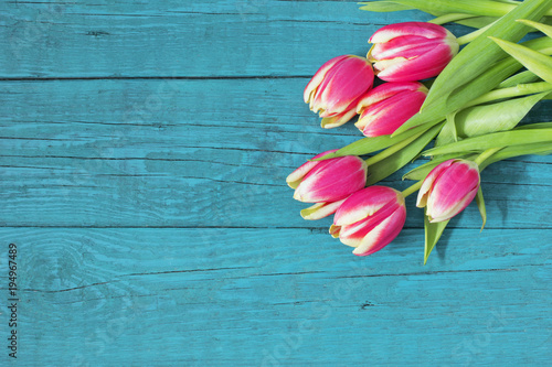 Beautiful fresh tulips on wooden background 