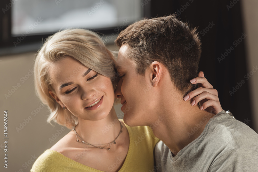 boyfriend kissing girlfriends neck at home