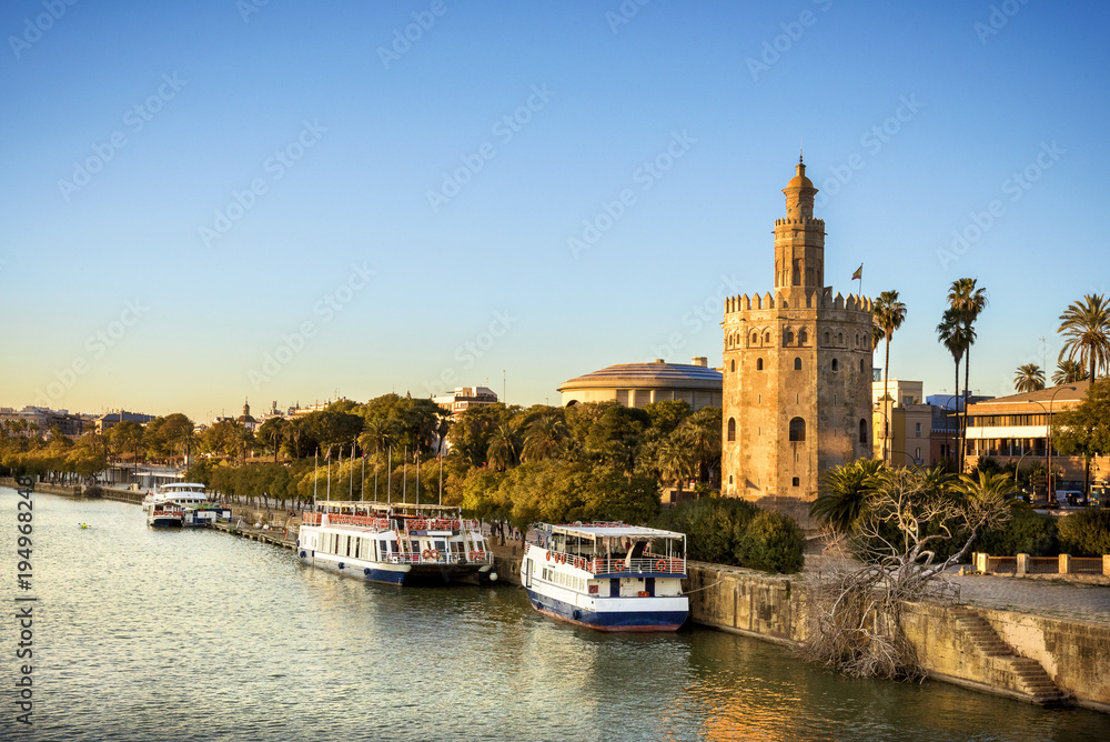 View of Golden Tower (Torre del Oro) of Seville, Andalusia, Spain over river Guadalquivir at sunset