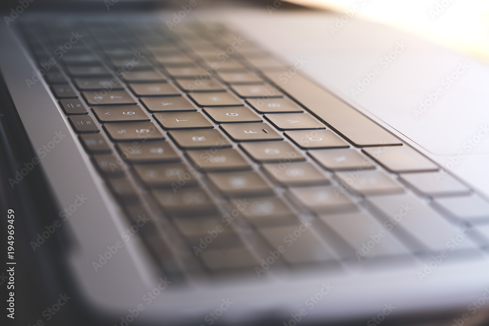 Closeup image of a laptop keyboard with blur background