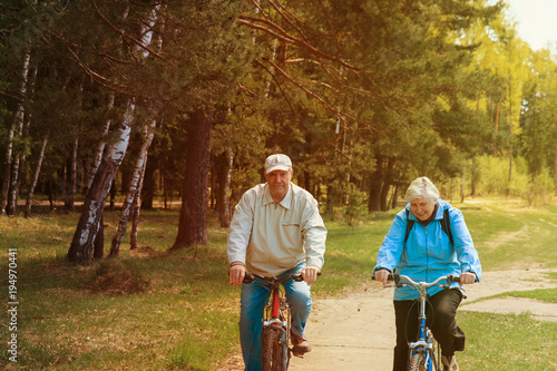 Senior couple riding bikes in nature