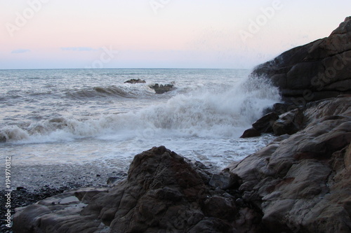 The landscape of the storm waves of the Black Sea fighting on the rocky shore.