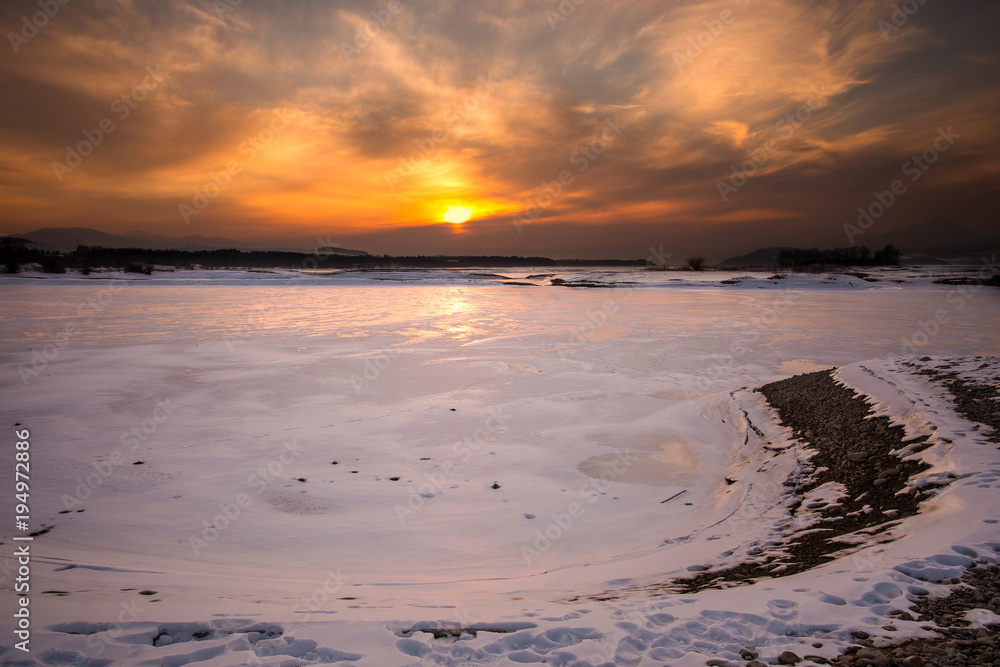 Sunset at frozen lake