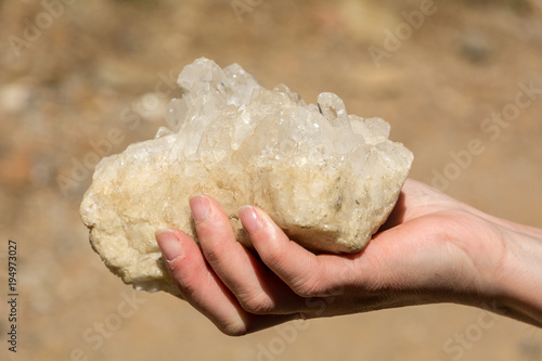 rose quartz in the natural state in one hand