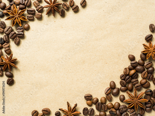 Coffee on paper background with coffee beans and star anise, copy space, top view.