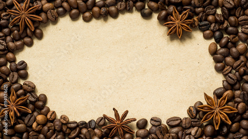 Coffee on paper background with coffee beans and star anise, copy space, top view.