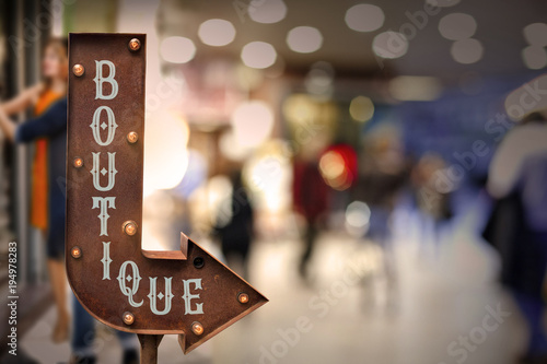 Boutique title signboard, in front of the store . Retro style photo