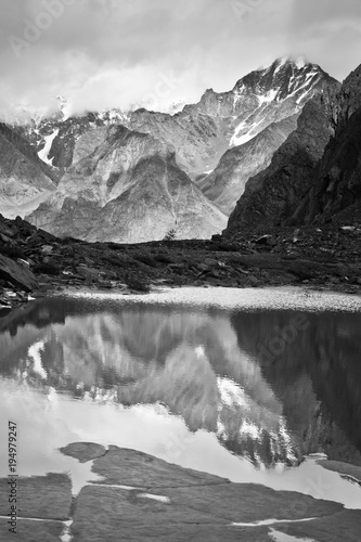 Beautifull valley with view to mountains and lake, black and white